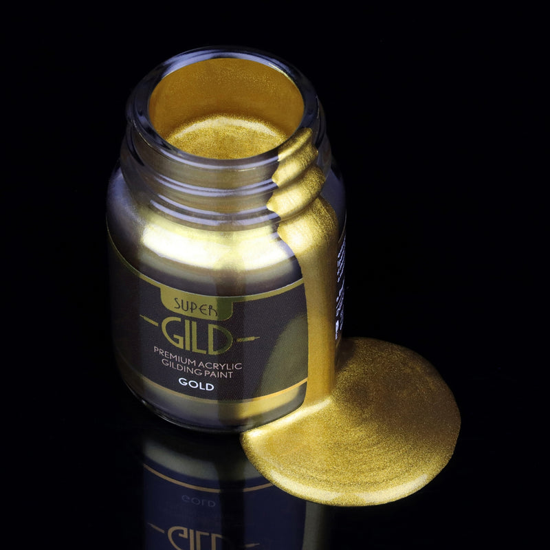 Super GILD Gold acrylic gilding paint in a jar with gold metallic paint pooling onto a black background
