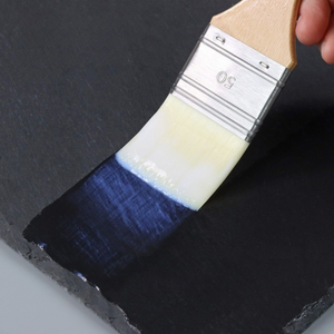 
                      
                        Paintbrush with top coat being applied to slate stone
                      
                    