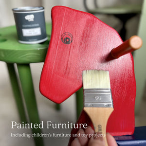 
                      
                        Red painted horse rocking chair with a brush on a blurred background
                      
                    