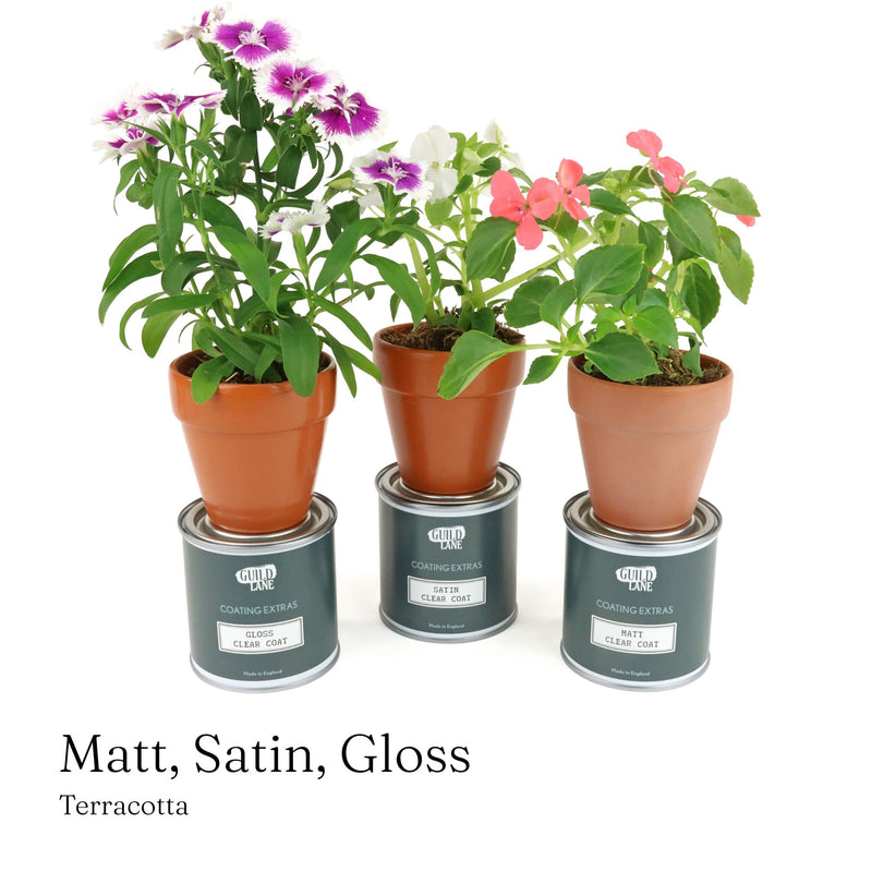 Three potted plants on top of three paint cans with 'Decorative Pots & Planters' text.