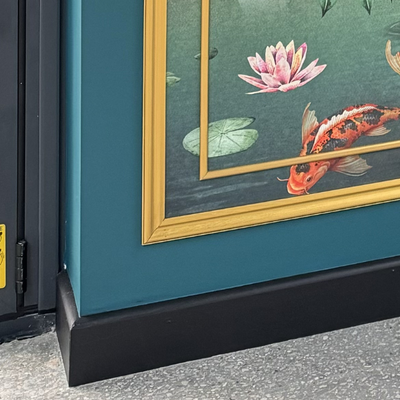 Framed artwork of koi fish and water lilies on a teal background.
