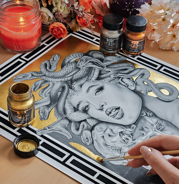 Black and white portrait art embellished with metallic gold paint