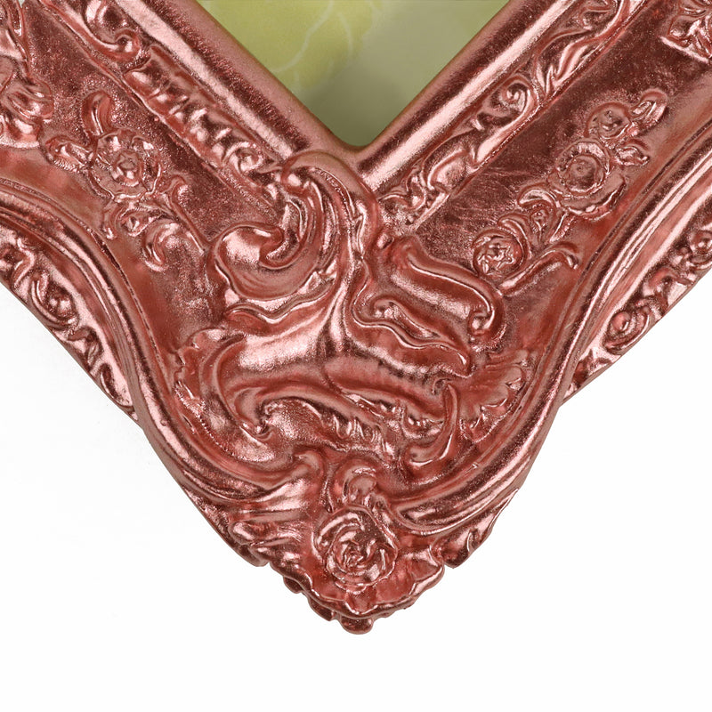 Rose gold painted corner of an ornate frame in metallic 