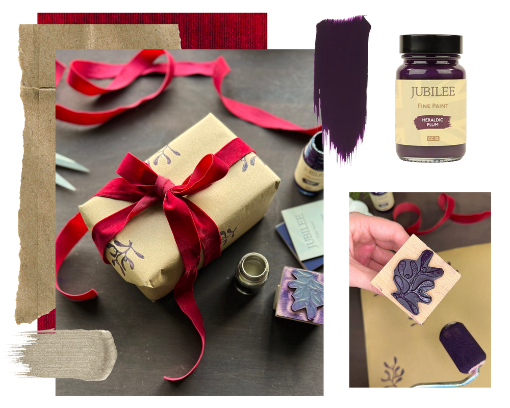 Collage of wrapped gift with red ribbon, paint bottles, and stamp on a dark surface.