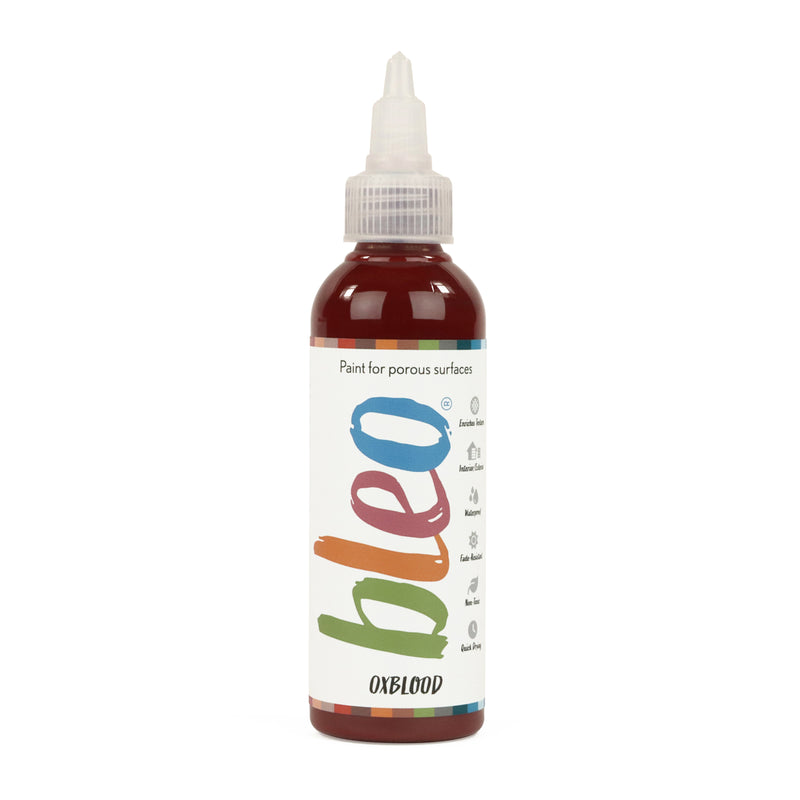A bottle containing coloured gel paint, on a white background of bleo oxblood