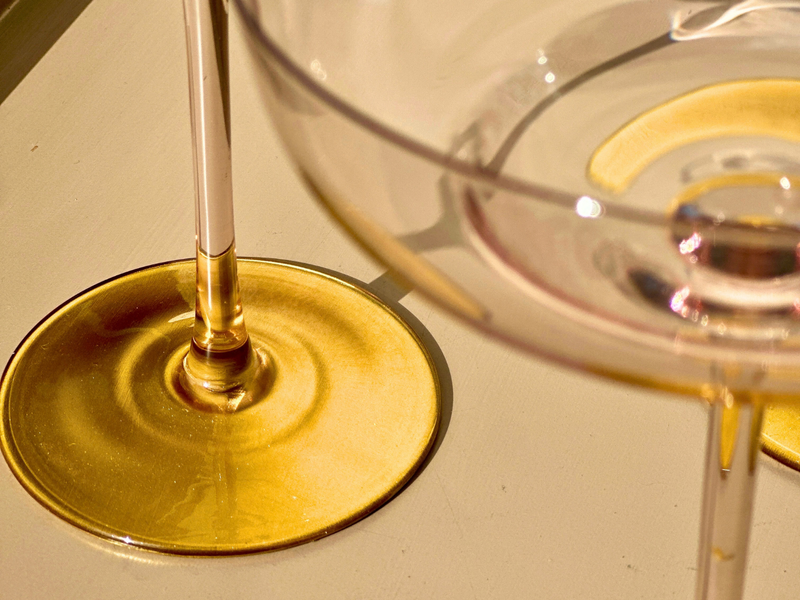 Champagne coupes with gilded feet catching the light