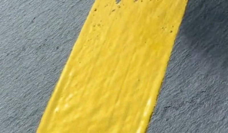 Super GILD Gold brushed onto slate in a single opaque stroke