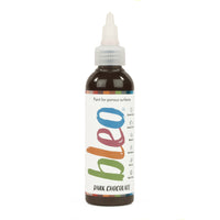 A bottle containing coloured gel paint, on a white background of bleo chocolate