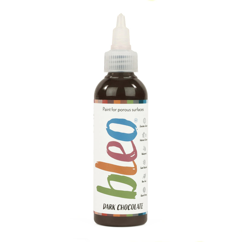 A bottle containing coloured gel paint, on a white background of bleo chocolate