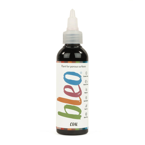 A bottle containing coloured gel paint, on a white background of bleo coal