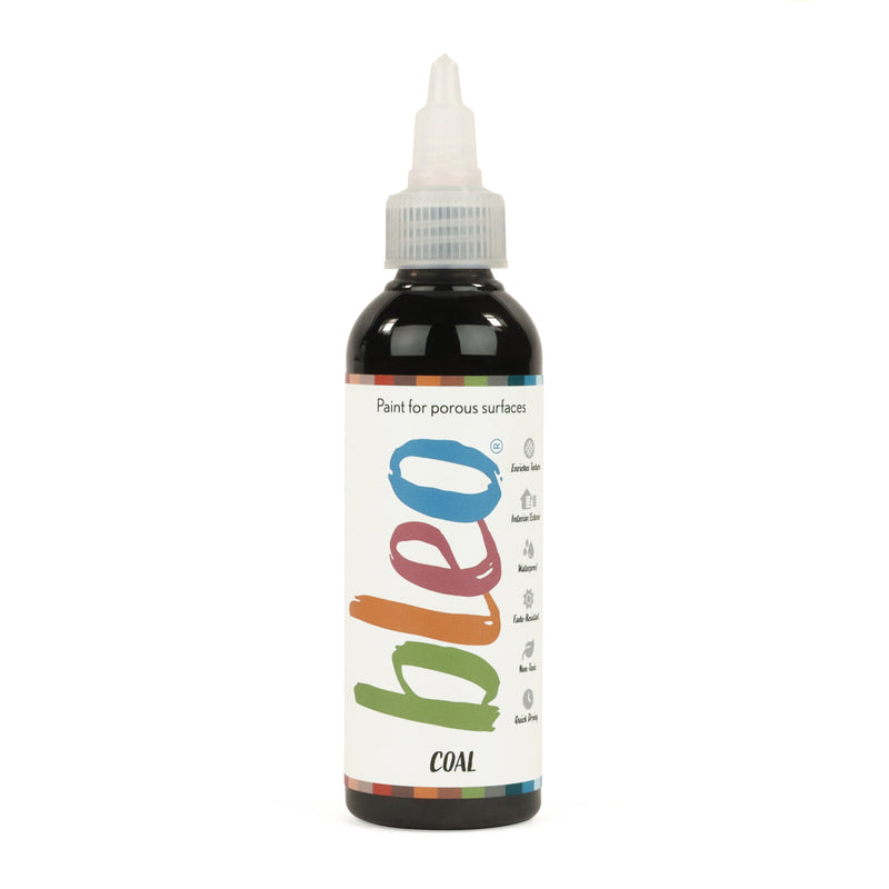 A bottle containing coloured gel paint, on a white background of bleo coal