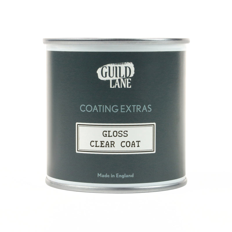 A bottle of Guild Lane gloss top coat with the label clear coat indicated as gloss finish for coating extras, made in England.