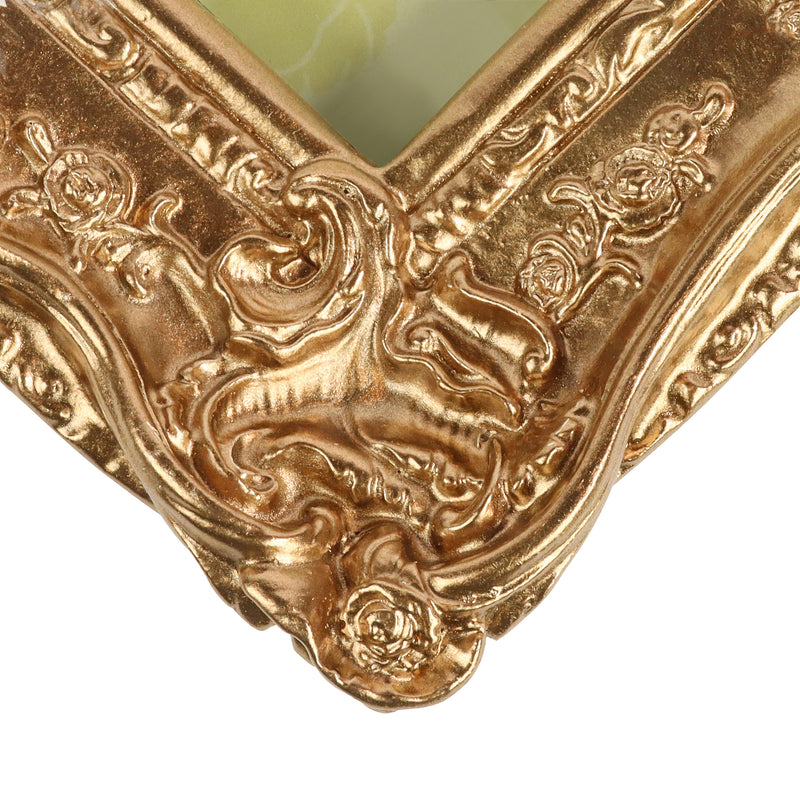 Bronze metallic painted corner of an ornate frame on a white background